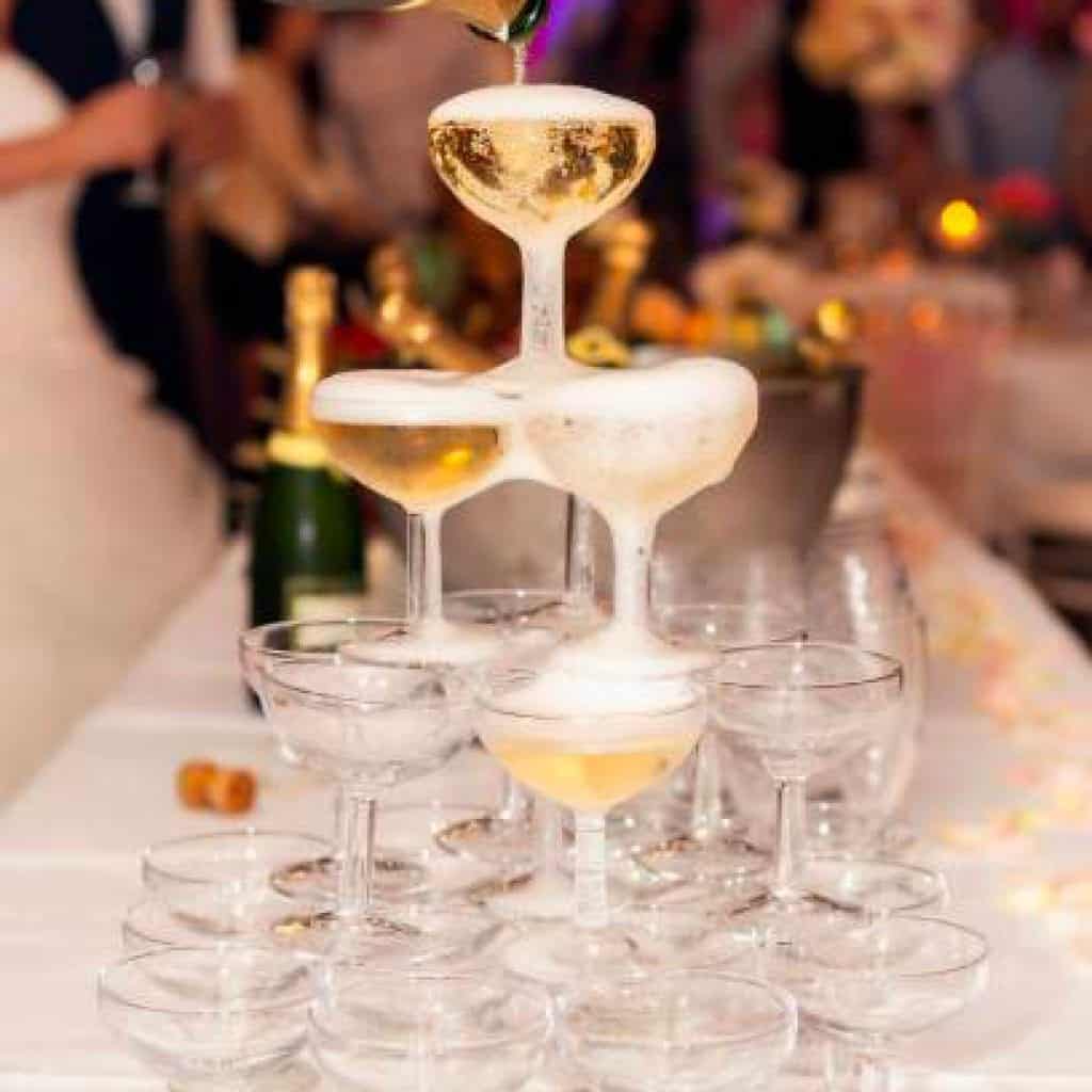 Champaign glass structure with someone pouring on